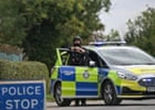 Police arresting men at night