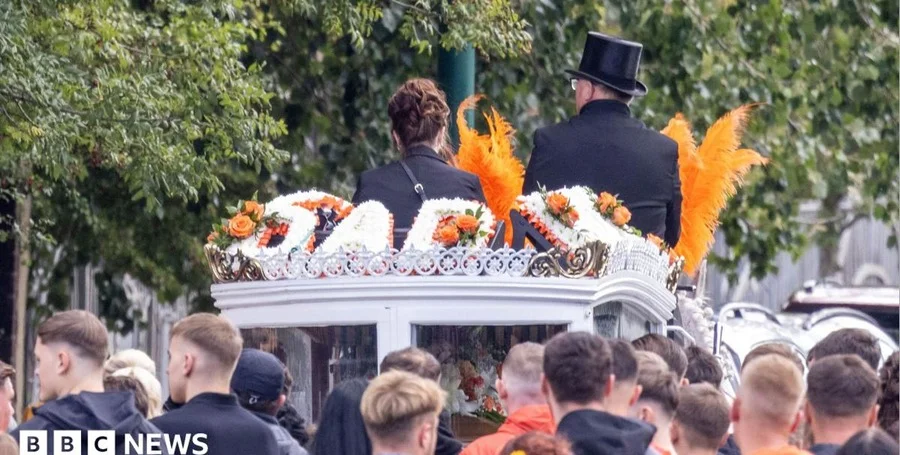 Mourners at a funeral service