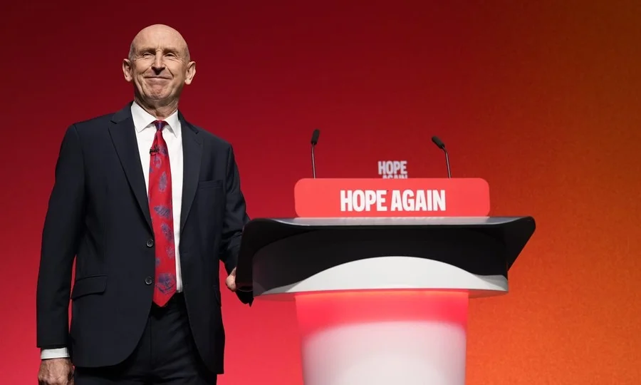John Healey speaking at podium